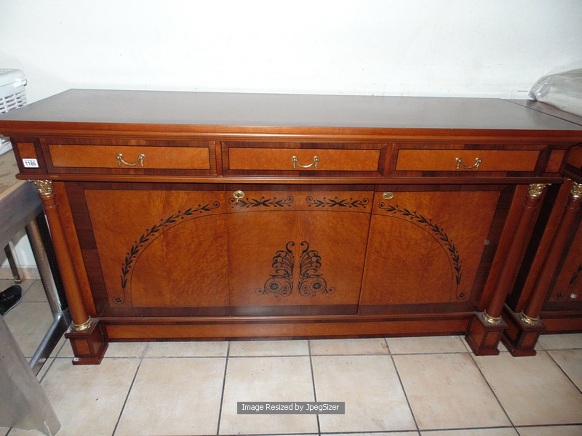 A flame mahogany sideboard in the French Empire style, with fluted quiver terminals, the straight