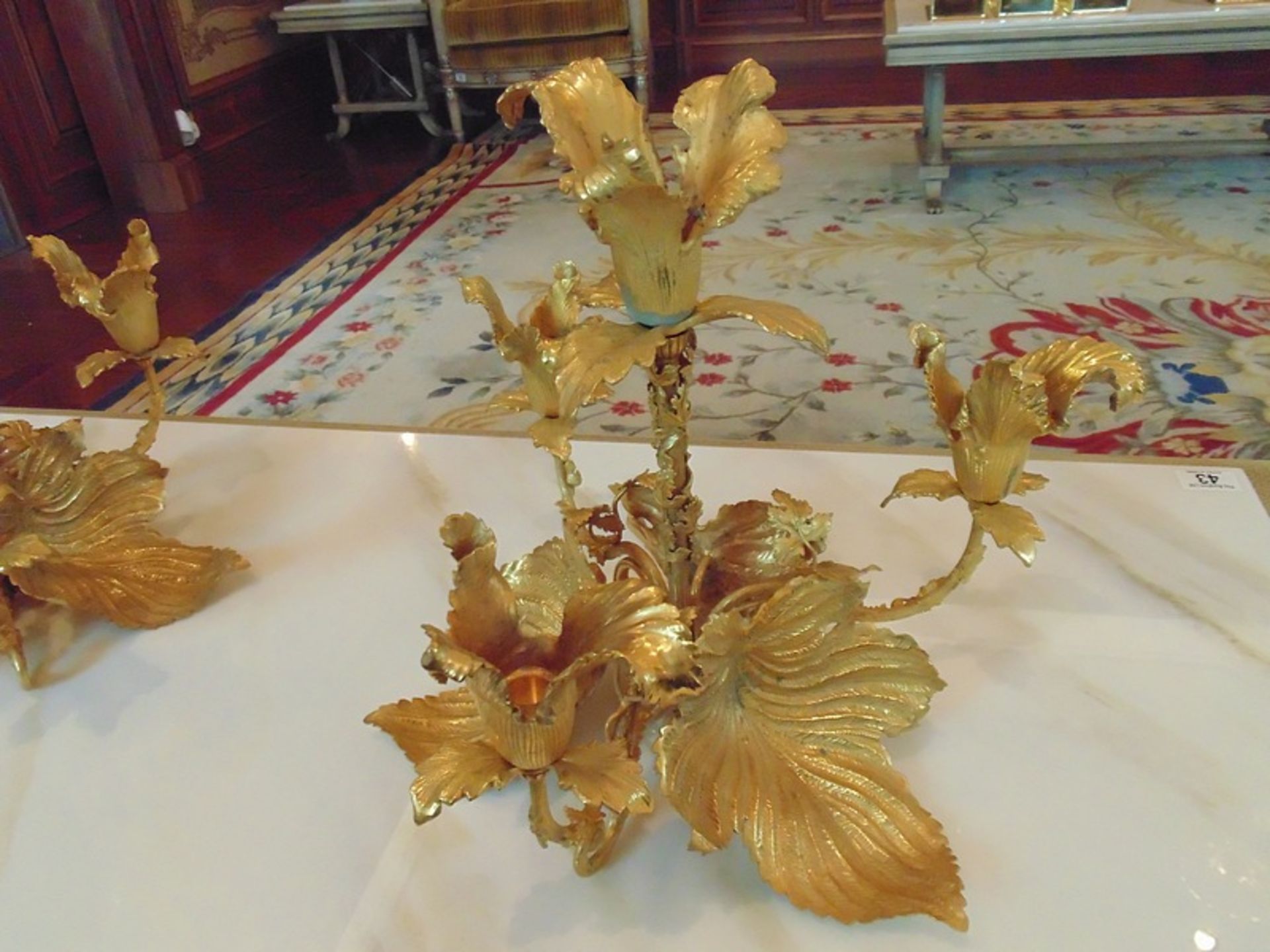 A pair of bronze with applied 24ct. gold leaf four branch candelabras in the form of a flower - Image 2 of 4