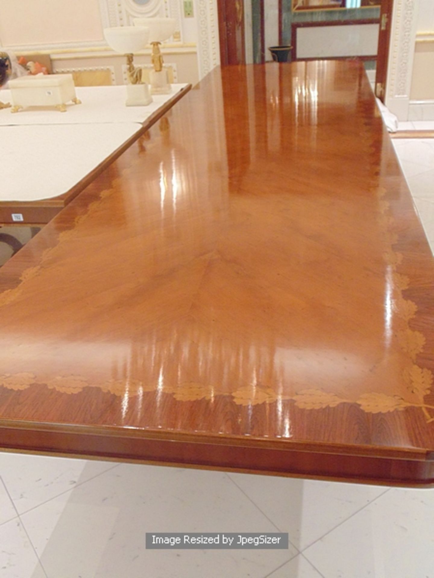 A Regency style mahogany and rosewood banded dining table, the mirror veneered top enclosed by - Image 12 of 12