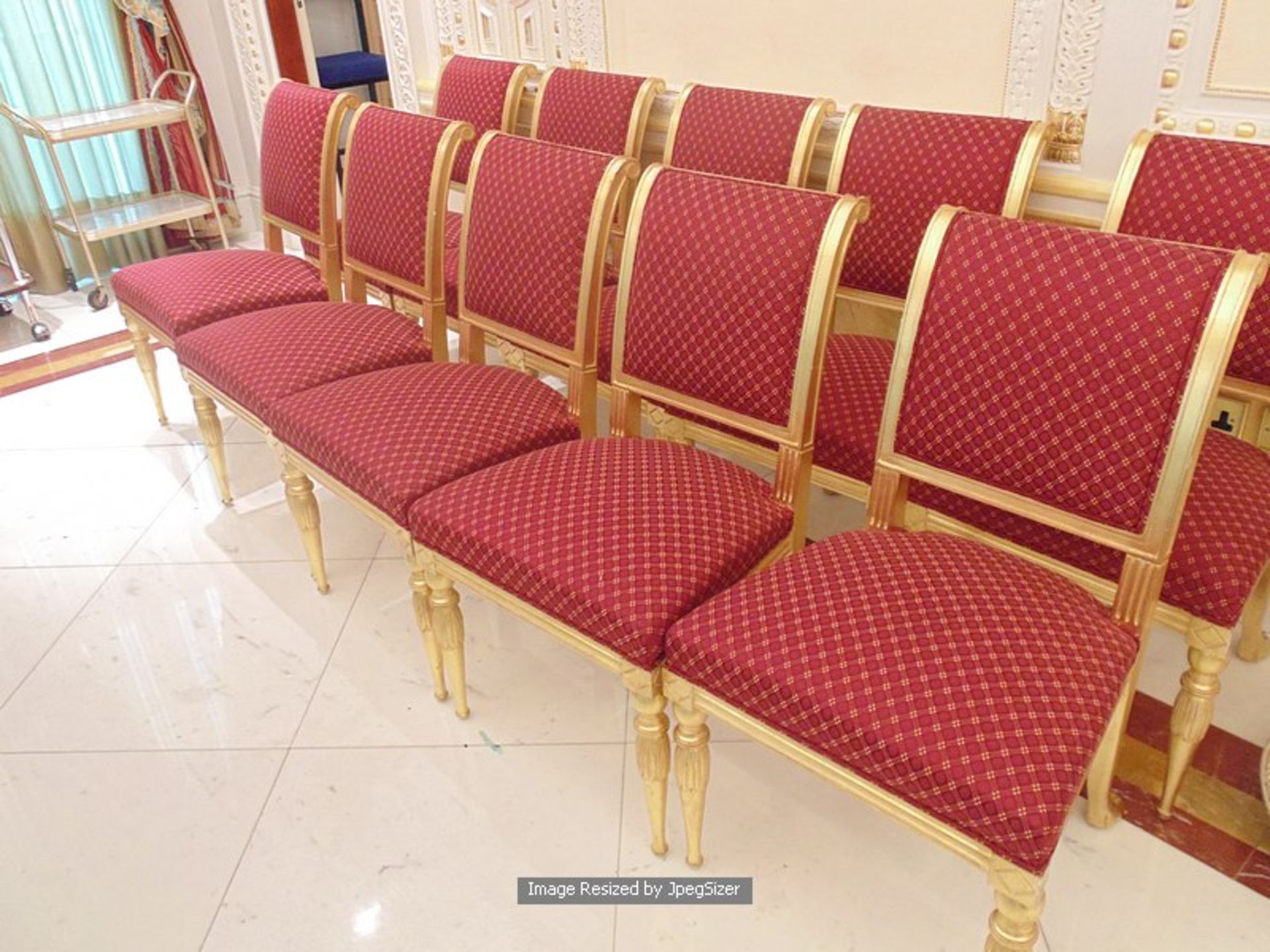 A set of 10 parcel-gilt dining chairs upholstered seat pad and backrest with splayed rear legs and