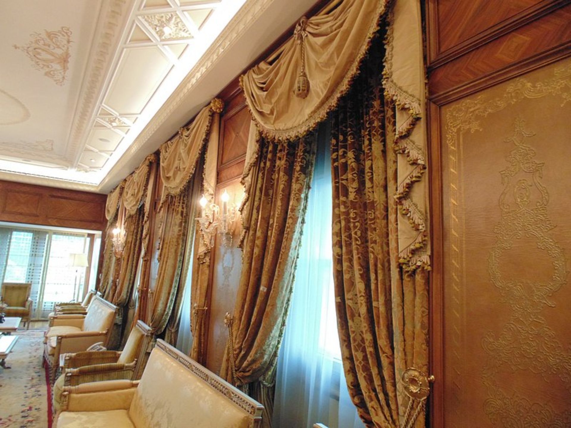 A pair of gold and burgundy curtains supplied by Jacquard from Rudolph Ackermann`s A series design