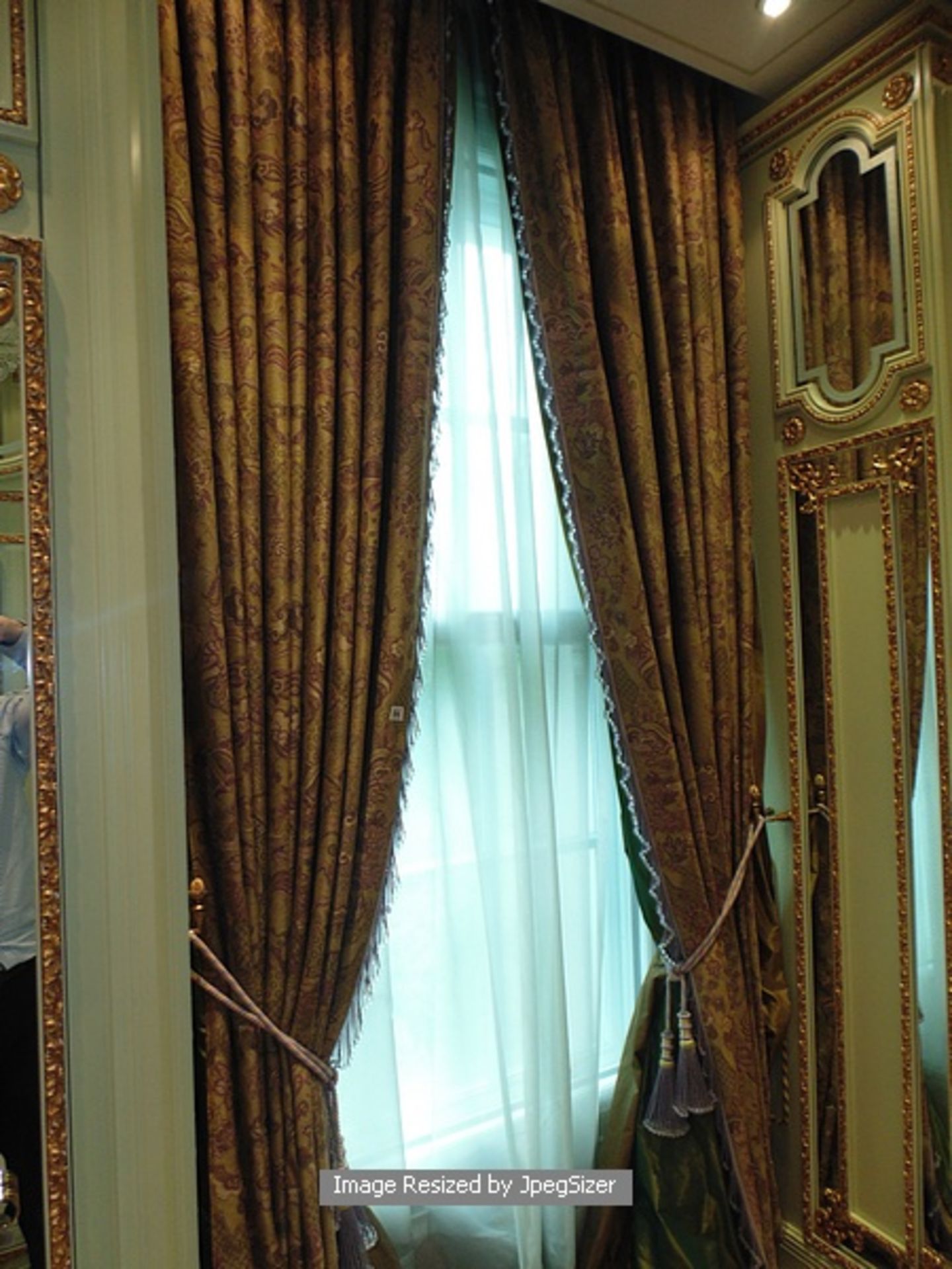 A pair of mauve and gold pattern curtains supplied by Jacquard, gold and mauve fabric from Marvi