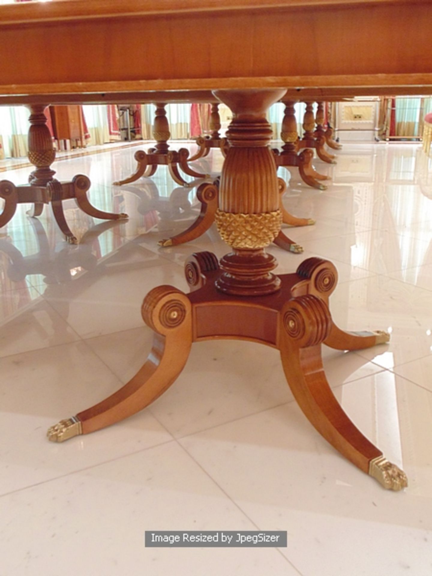 A Regency style mahogany and rosewood banded dining table, the mirror veneered top enclosed by - Image 8 of 12