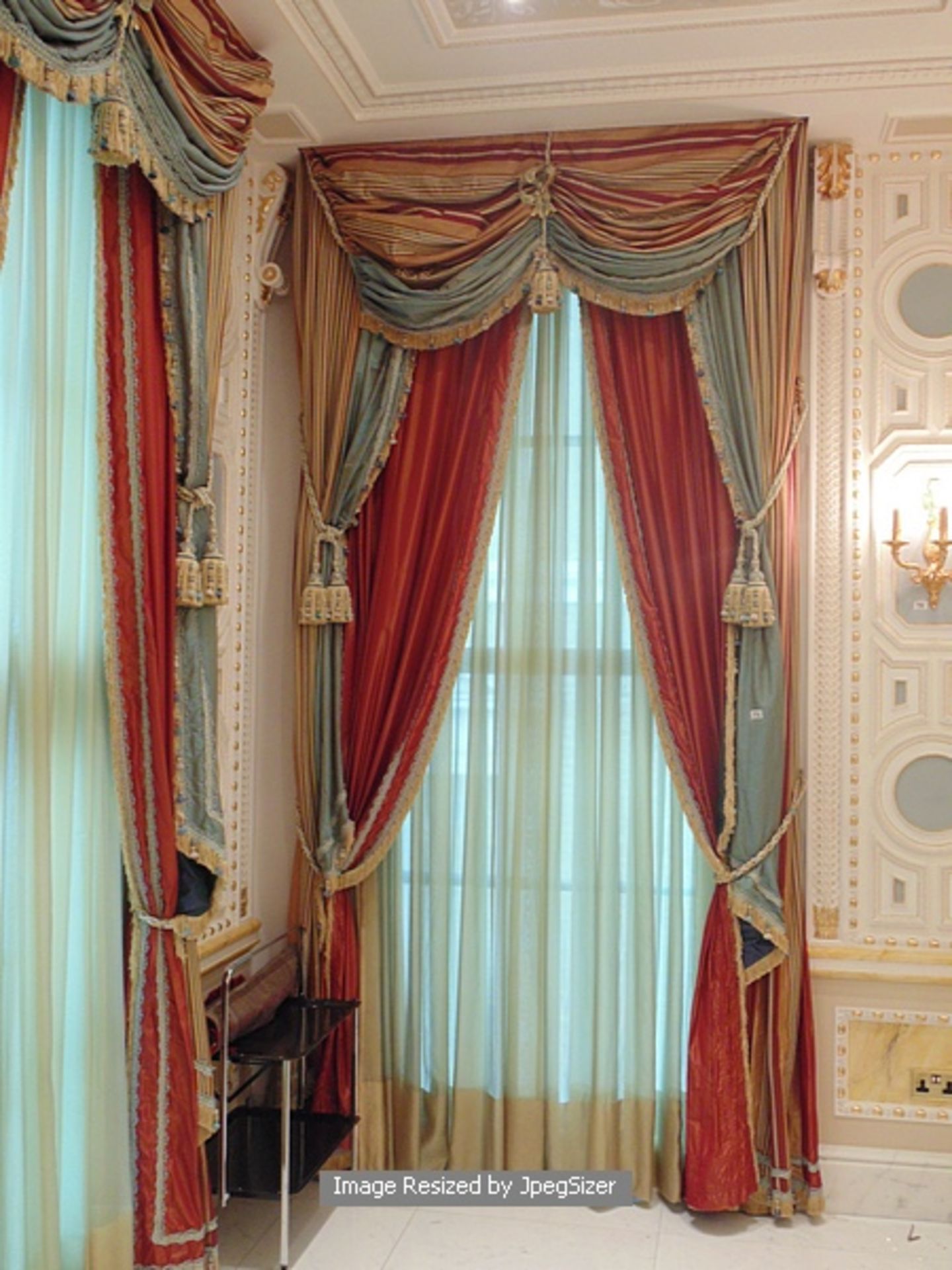 A pair of gold and aquamarine curtains supplied by Jacquard from Rudolph Ackermann`s A series design