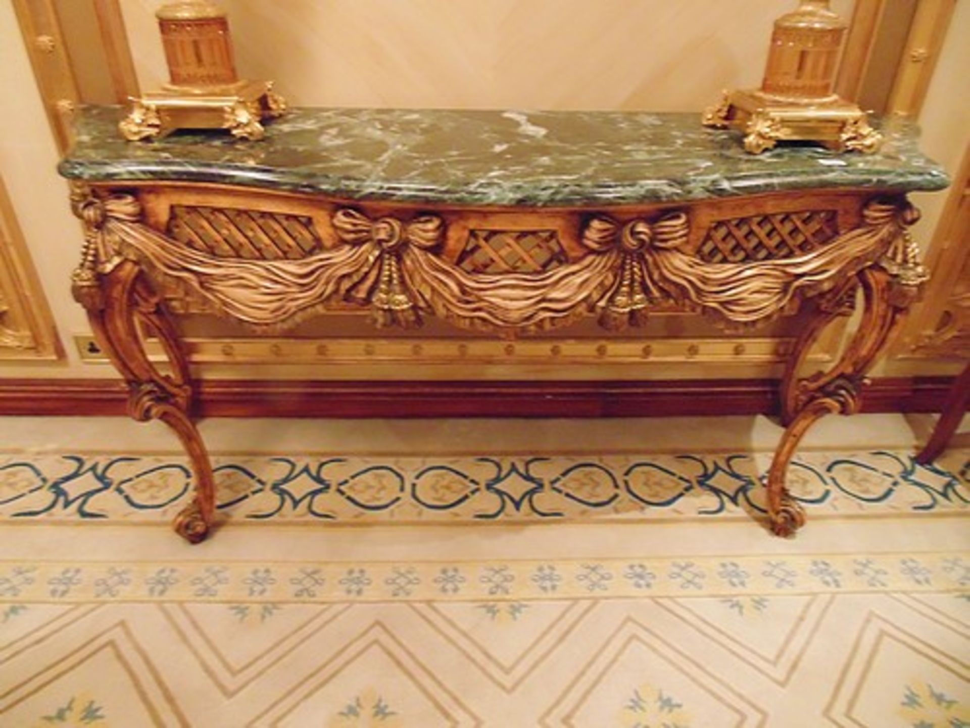 Continental bombe mahogany and console table with a Verde marble top above a carved apron with swags
