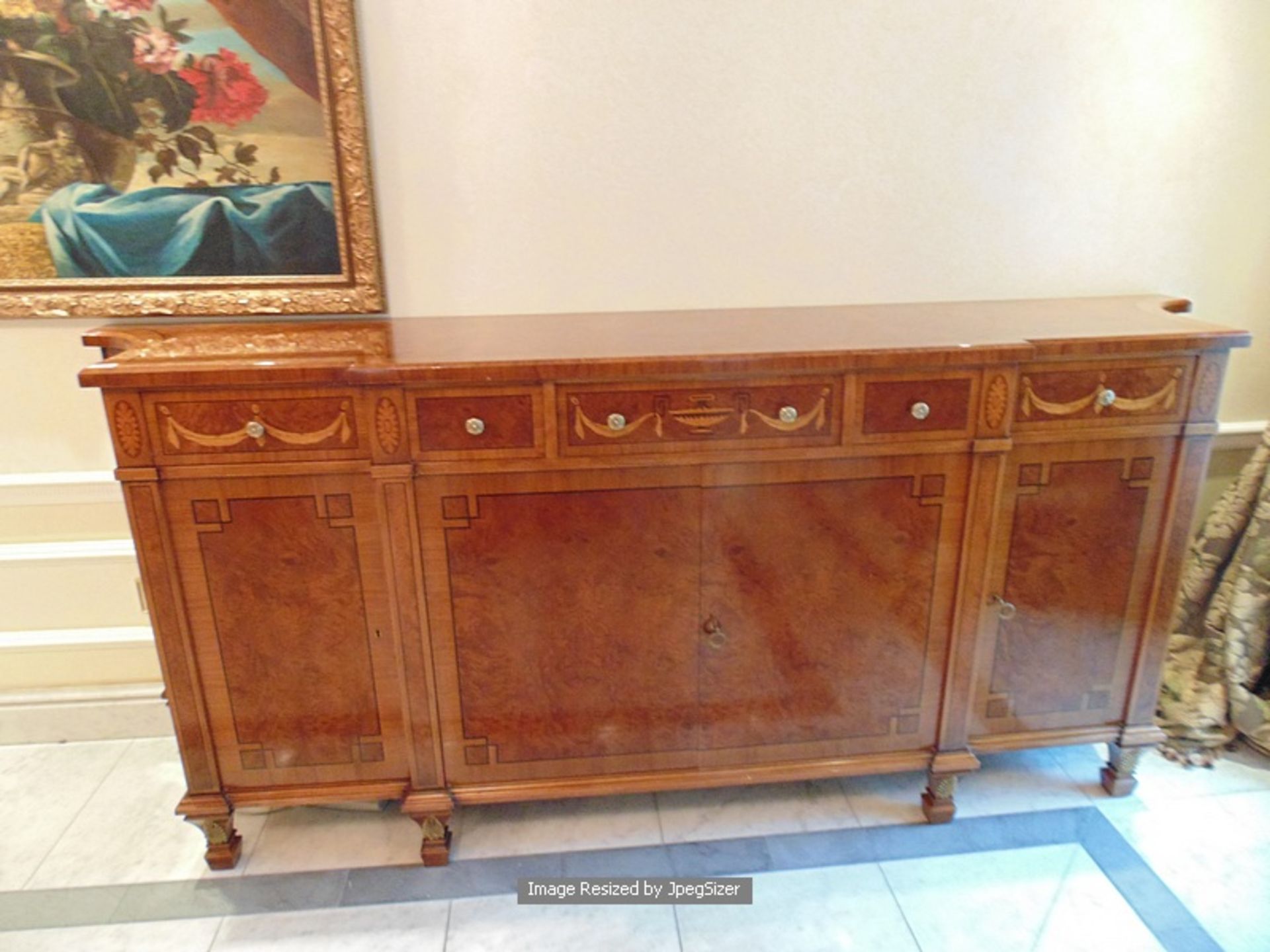 A burr mahogany breakfront sideboard in the French Empire style, with fluted quiver terminals, the