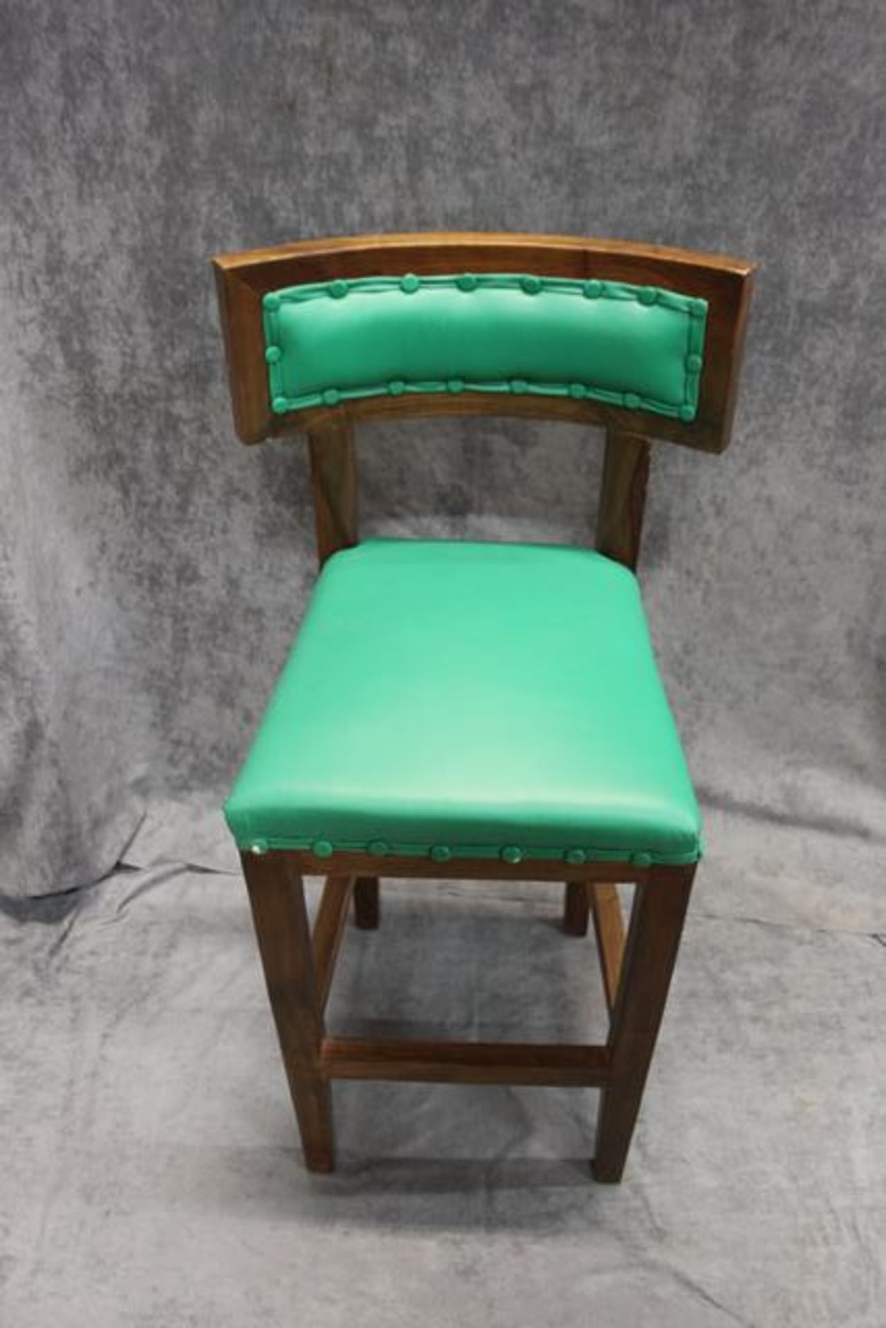 A pair of contemporary green bonded leather bar stool polished walnut finish frame with a studded