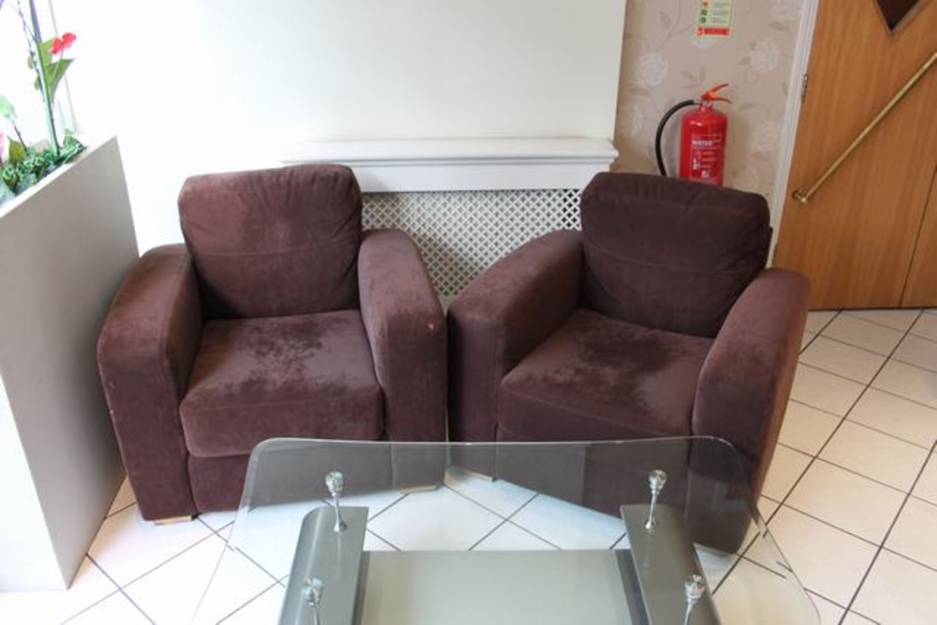 A pair of upholstered chocolate brown arm chairs with soft loose cushions  Lift out charge  5