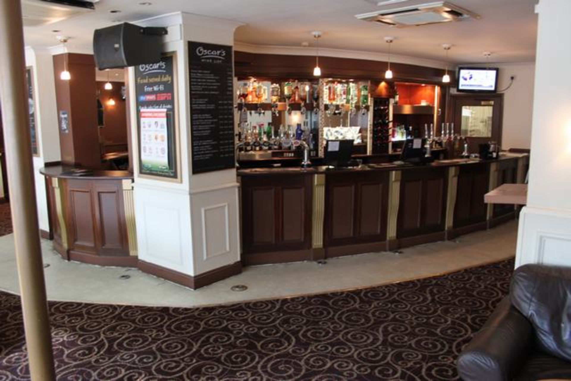 Complete bar counter comprising of mahogany stained horseshoe shape spanning 14m the front carved