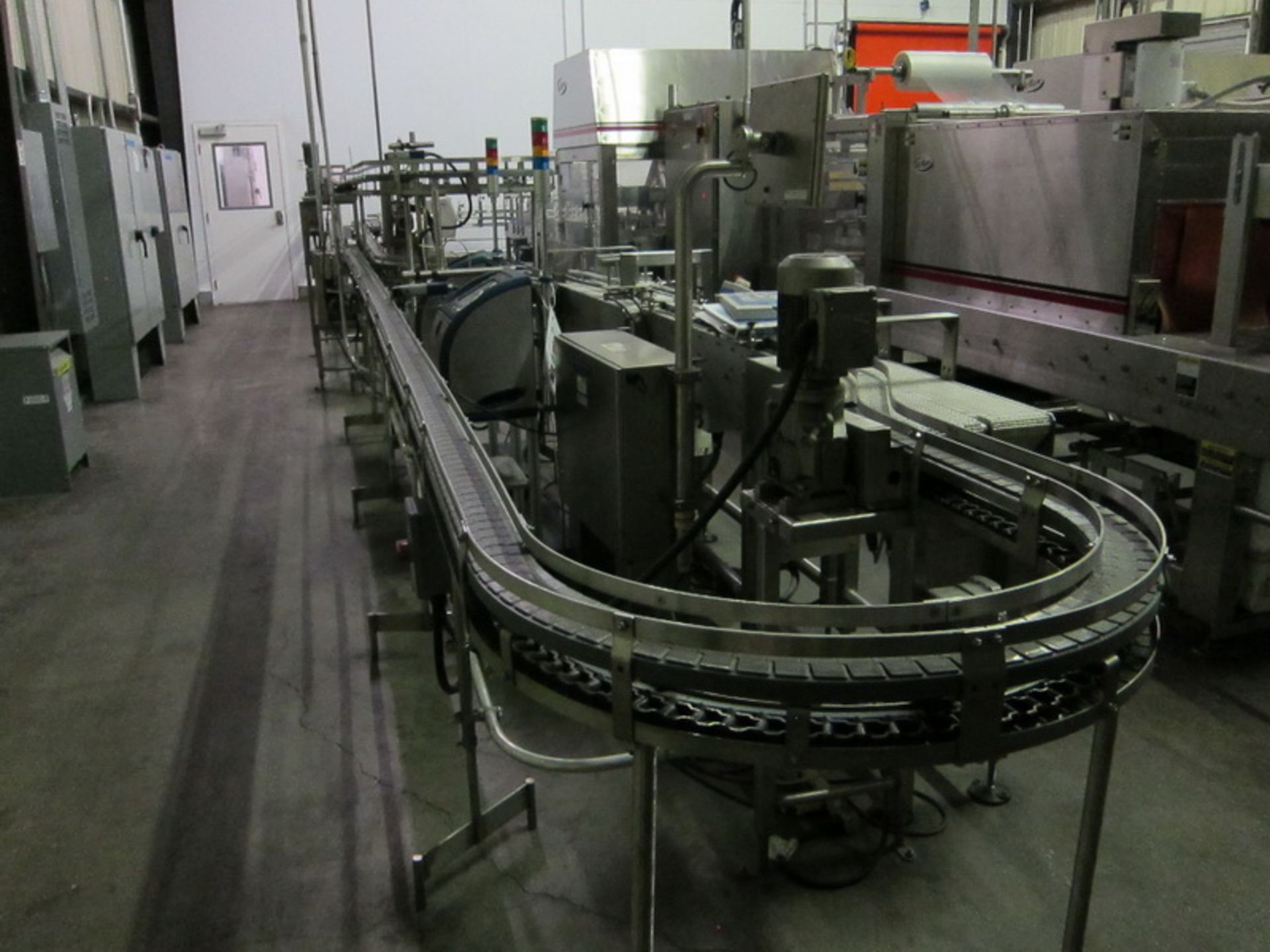 [Lot] Dairy Conveyor Corp. table top conveyors, extending from filling room to checkweigh in tray