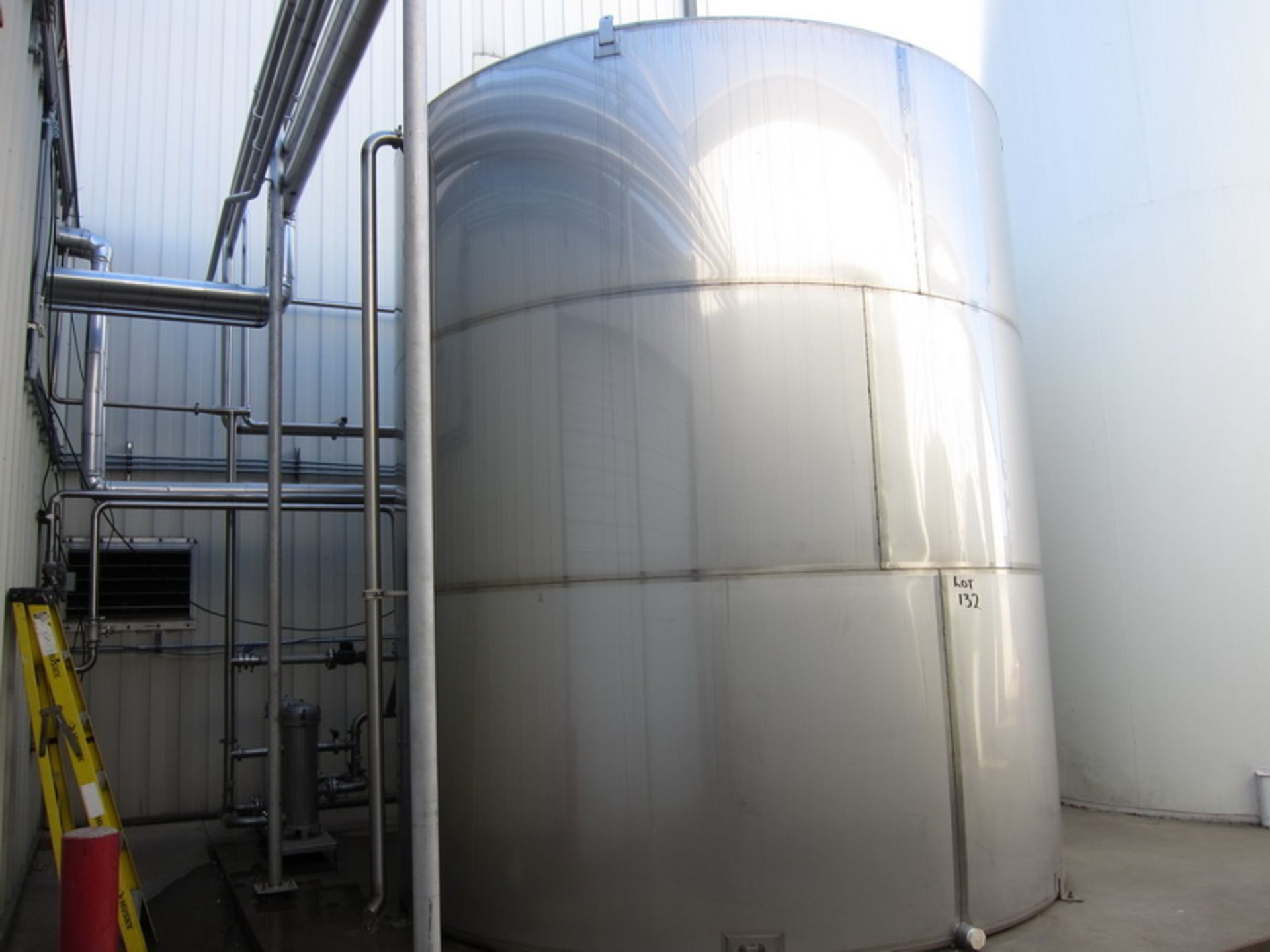 Hot water holding tank, SS 15,000 gallons approx. capacity, with (2) pumps & (2) USF Filtration