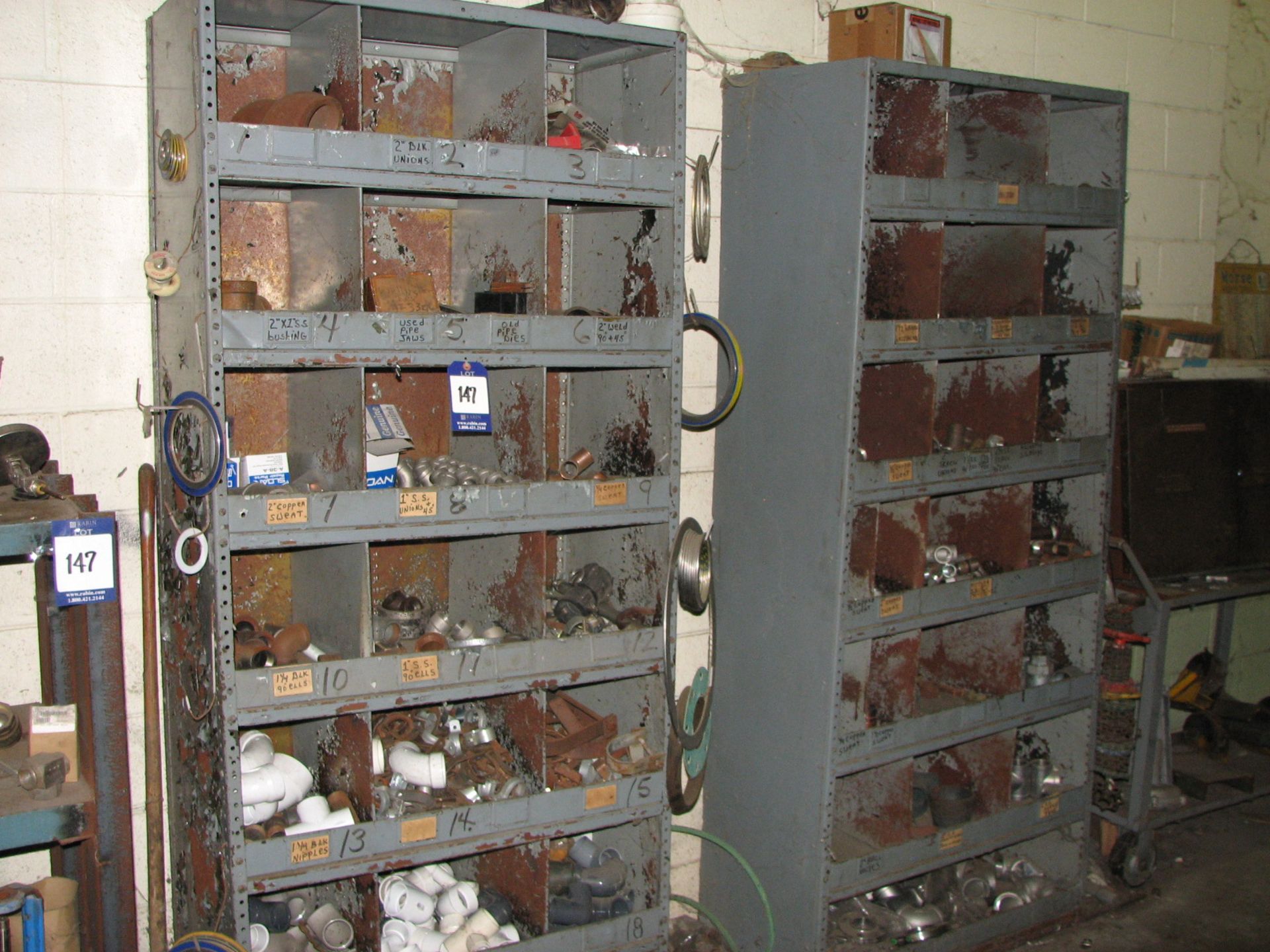 [Lot] Miscellaneous galvanized, PVC, fittings, elbows, couplers with (2) metal shelf units, (1)