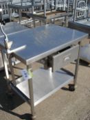 STAINLESS STEEL TABLE WITH CAN OPENER HOLES IN TOP WITH DRAW ON WHEELS - 35.5" X 25.5" X 36"