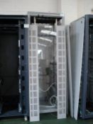 Computer racking. Light grey metal. Loose glass panels.