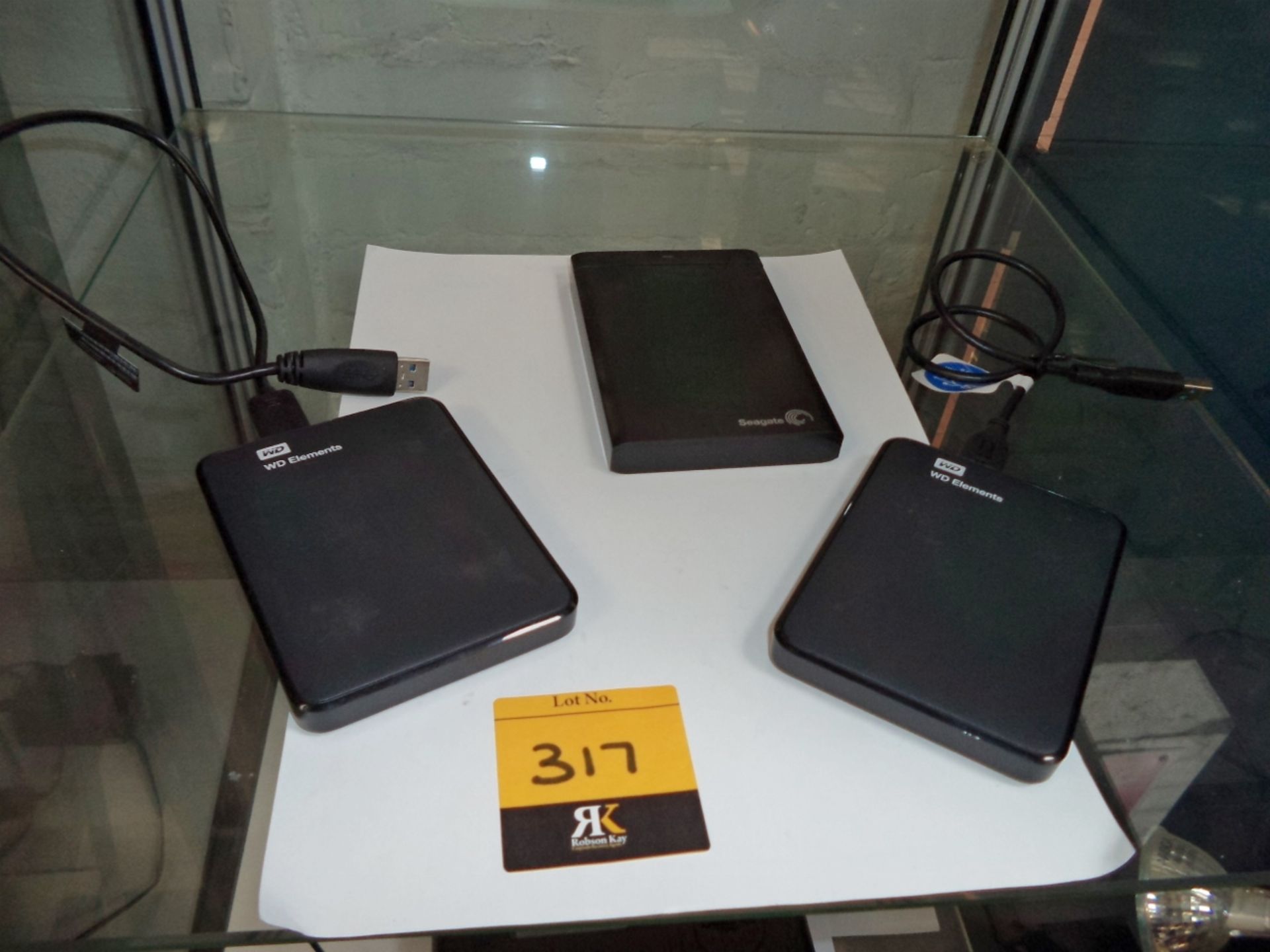 3 off assorted external hard drives, consisting of 2 Western Digital 1Tb drives, part number