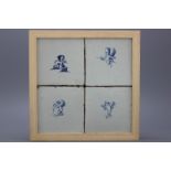 A framed set of 4 Dutch Delft tiles with amors 17th C. A framed set of four Dutch Delft blue and