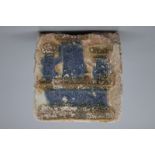 A Spanish olambrilla tile, Seville, first half 16th C. Decorated in relief with a castle in blue and