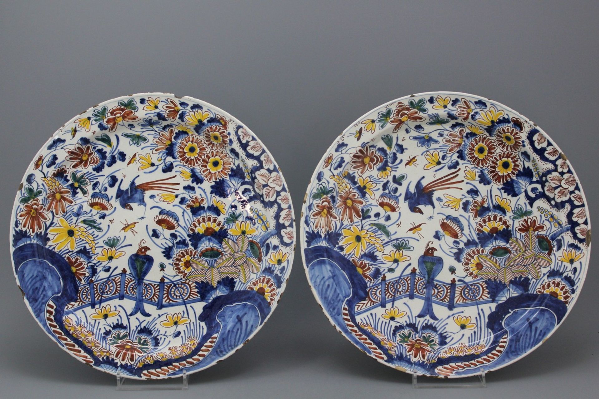A pair of large polcyhrome Dutch Delft dishes with birds and flowers, 17th C. A pair of large