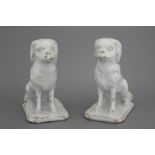 A pair of Dutch Delft monochrome white figures of dogs, 18th C. Both naturalistically modelled on