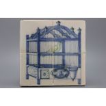A Dutch Delft blue and yellow tile panel with a bird in a cage 19th C. Consisting of 4 tiles,