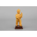 A Chinese carved wood figure of a boy with corn, Cultural Revolution, 20th C. Conditon: Perfect.