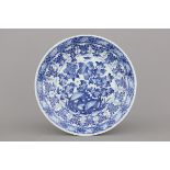 A Chinese porcelain blue and white dish, Kangxi, early 18th C. Dia: 35,5 cm. Some wear to the edges.