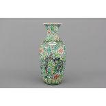 A Chinese famille verte vase with a dragon, 19th C. H: 44 cm