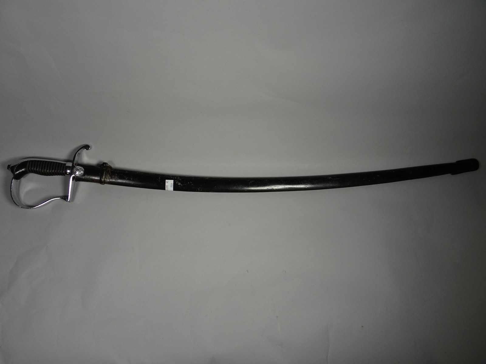 A German Democratic Republic sword with scabbard and insignia on crossguard