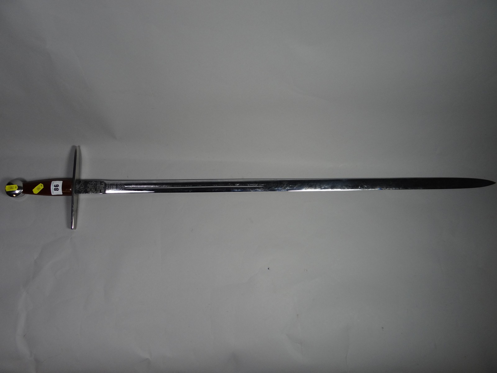 A Crusader-style Wilkinson-made sword with polished wooden handle and steel crossguard