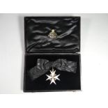 An Order of St John breast badge on ladies bow in silver and enamel in fitted velvet-lined case of