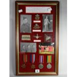 A framed group of medals consisting of 1939-45 Star, Burma Star, WWII Defence and War Medals,