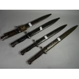 Four bayonets of the world all with scabbards, including one with Siamese marked blade