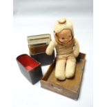 An circa 1920s three-faced doll with rotating head revealing a baby happy, sad and asleep,