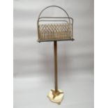A pedestal magazine stand, the brass mesh basket held aloft by a gilt guilloche decorated tri-column
