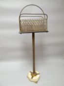 A pedestal magazine stand, the brass mesh basket held aloft by a gilt guilloche decorated tri-column