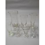 Seven nineteenth century and early twentieth century glass pharmacy measures