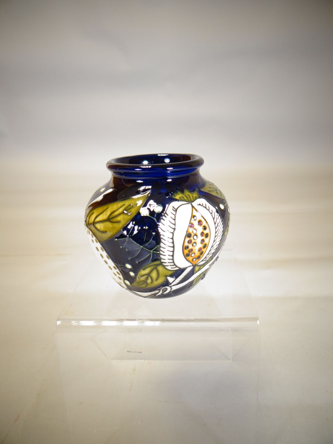 A small Moorcroft pottery vase in the 'Honeymoon' pattern, 3 ins high (8 cms)