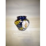 A small Moorcroft pottery vase in the 'Honeymoon' pattern, 3 ins high (8 cms)
