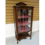 An inlaid mahogany single door china cabinet with shaped lower tier and leaded glass, 54 ins high (