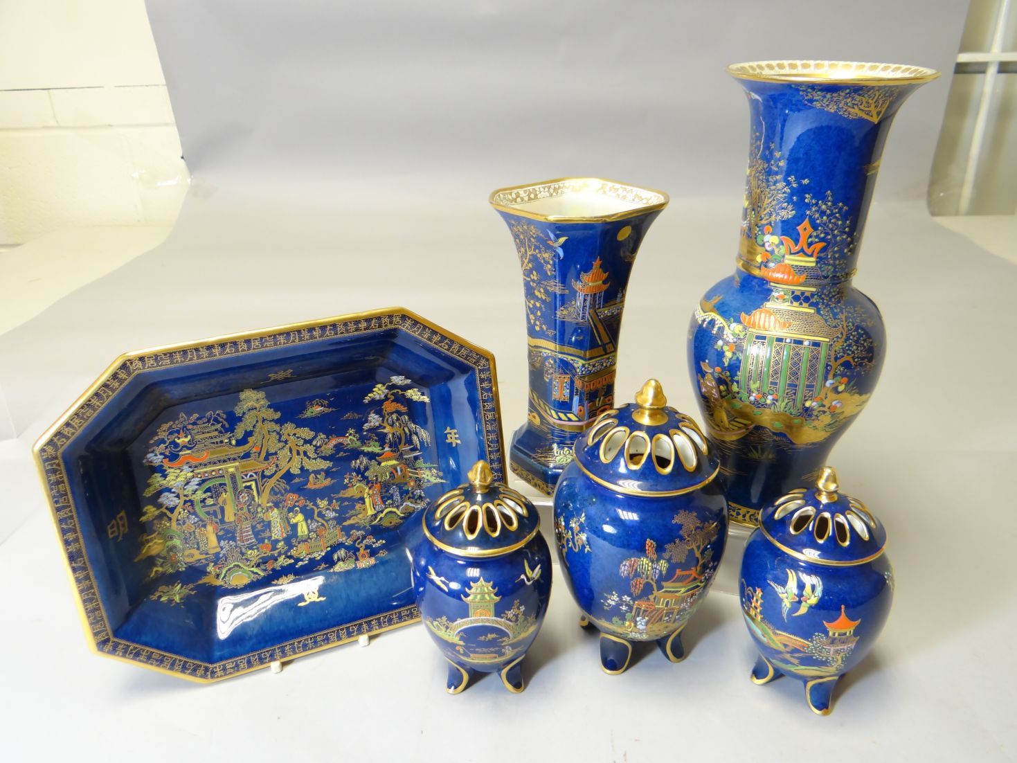A suite of Carltonware blue ground china with matching lustre decoration and Chinese landscape