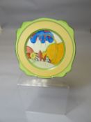 A Clarice Cliff Bizarre tea plate of shaped form and with inner stylised landscape scene, 9 ins