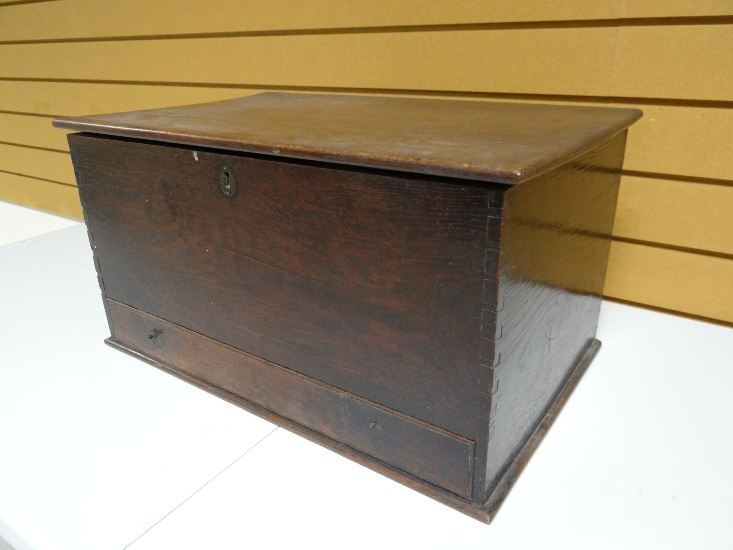 A primitive oak coffer-bach with single base drawer, 23 ins wide (59 cms)