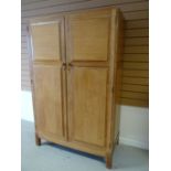 A light oak Brynmawr Furniture 'Merthyr' double wardrobe, having panelled doors and with interior