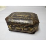 A Chinese lacquer ware octagonal writing box on claw fore-feet, hinged lid above single drawer,