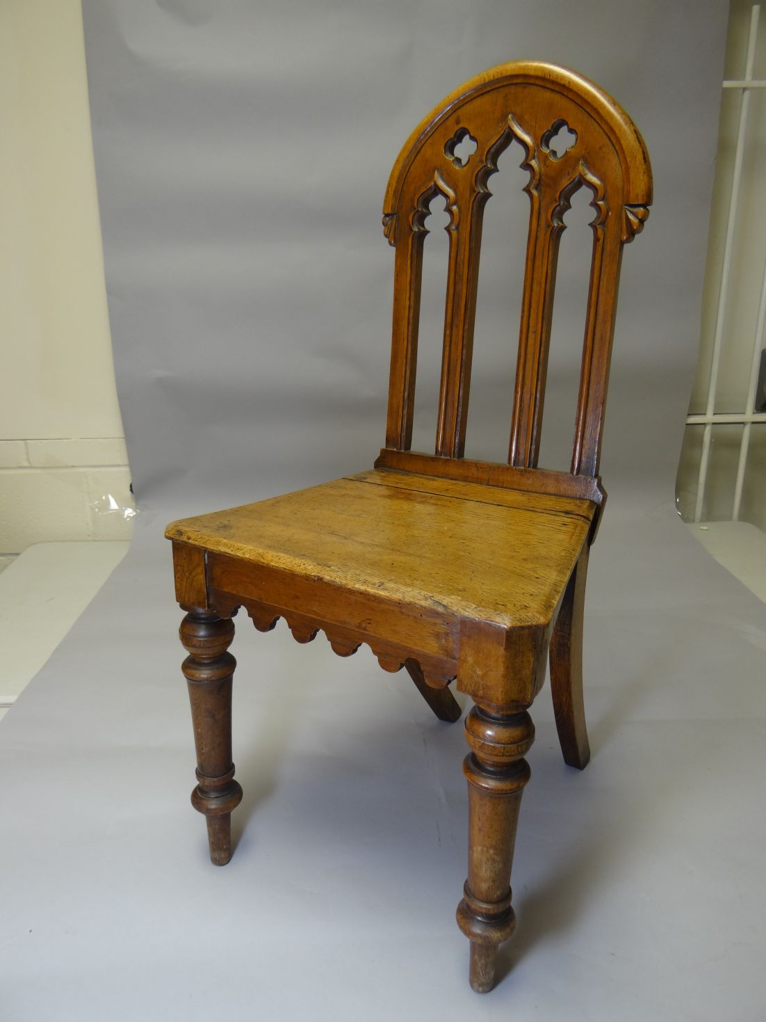 A Gothic-revival oak hall-chair (distressed)