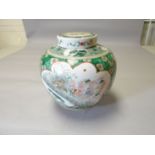 An early twentieth century Famille Vert lidded, bulbous ginger jar profusely decorated with panels