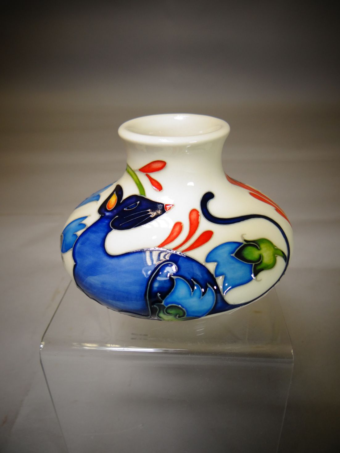 A Moorcroft pottery squat vase in the 'Fiery Mouse' pattern, 3.25 ins high (8 cms)