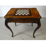 An antique multi-wood galleried shaped games-table, having an inset marble chequer board on bow-legs