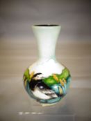 A Moorcroft pottery onion shaped vase in the 'Pied Wagtail' pattern, 7 ins high (18 cms)