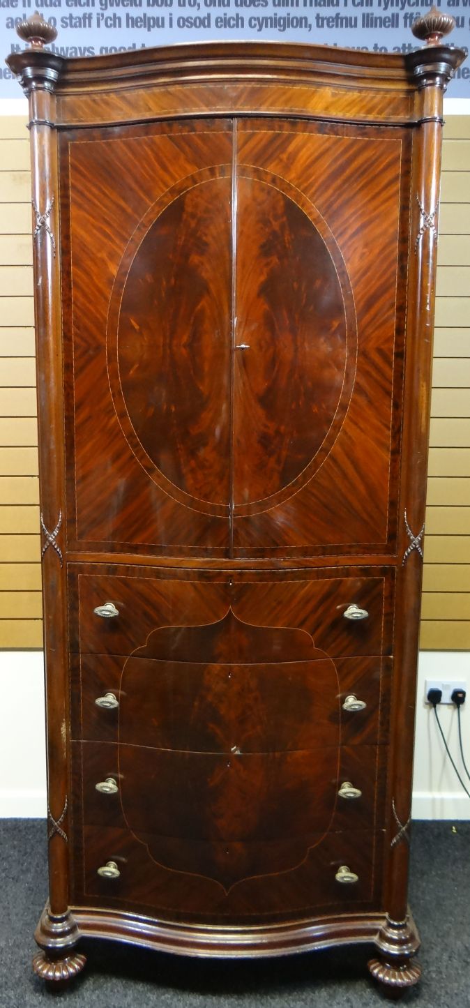 A late nineteenth century mahogany press-cupboard by Maple & Co, of serpentine-form with four